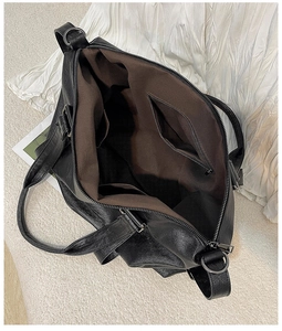 Large black tote bag with smooth metal zipper and spacious interior organizational pockets