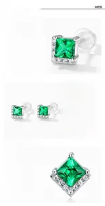 Macro detail of square-cut emerald earrings in S925 sterling silver with four-prong setting