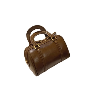 Mini dark brown Boston bag in glossy leather with gold zippers and round handles