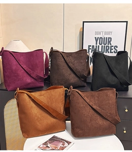 Group view of multi-color matte suede tote bags in minimalist bucket bag styles