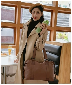 Brown leather large tote bag styled with a beige trench coat and a vintage beret hat