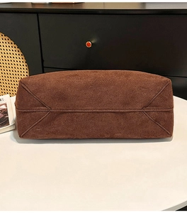 Detailed base view of brown suede tote bag showing precise stitching and structural bottom