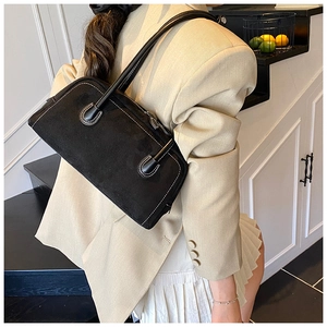 Black matte shoulder bag with white contrast stitching for women's daily commute