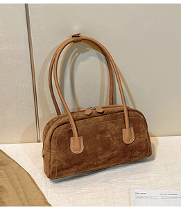 Detail of vintage brown suede handbag with double zippers and elegant stitching finish