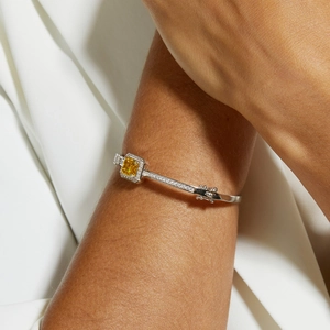 Close-up of S925 silver bracelet with square yellow gemstone and diamond pavé settings