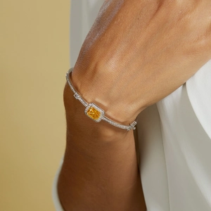 Macro shot of S925 silver bracelet featuring radiant rectangular yellow gemstone setting