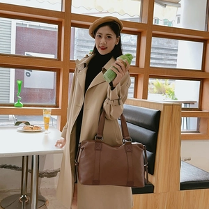 Women's brown pebbled leather handbag with large capacity and stylish top handles