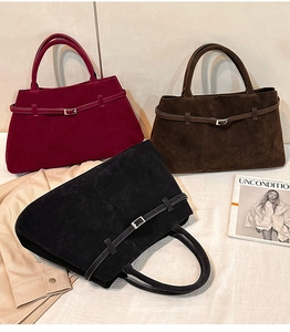 Détail de sacs cabas vintage mats en noir, marron et bordeaux avec des boucles en métal