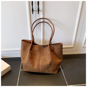 Classic large brown faux suede tote bag with slim shoulder straps for daily commuting