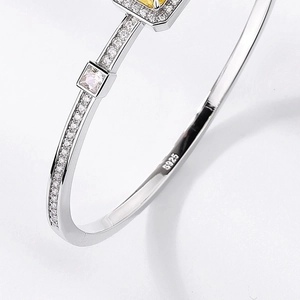 Elegant S925 sterling silver bangle featuring a square yellow diamond and white stones