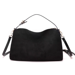 Minimalist matte black handbag with golden hardware and adjustable strap for women