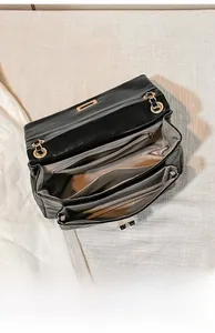 Top view of black quilted crossbody bag showing spacious interior and multiple compartments