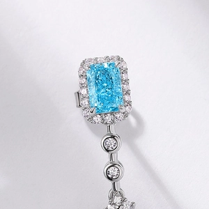 Elegant S925 silver drop earrings featuring a radiant-cut blue gemstone with halo setting