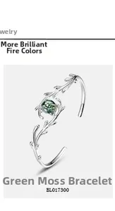 Macro detail of silver branch bangle with round green moss agate stone and leaf texture