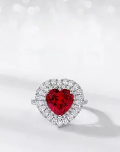 Macro shot of S925 silver ring featuring heart-cut red ruby and brilliant pavé diamonds