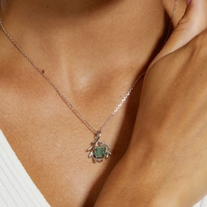 Close-up of S925 silver moss agate pendant with natural tree branch branch design