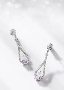 Detailed view of pear-cut moissanite drop earrings with sparkling three-prong silver setting