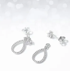 Macro detail of S925 silver moissanite earrings with detachable pear-shaped drop design