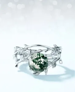 Macro shot of silver vine band with round moss agate stone and small diamond accents
