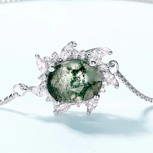 Elegant S925 silver bracelet featuring oval moss agate gemstone with sparkling zircons