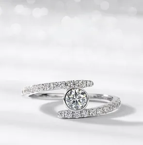 Macro detail of moissanite ring with bezel setting and pavé diamonds on twist band