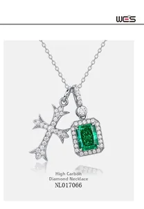 Macro detail of S925 silver cross and emerald-cut green gem pendant necklace
