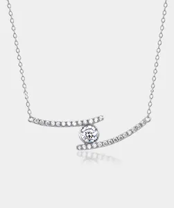 Macro shot of silver bow pendant with shimmering moissanite and intricate diamond accents