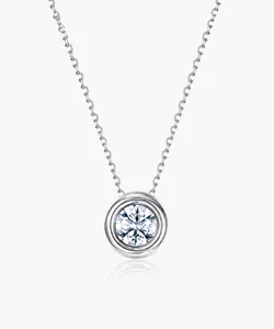 Macro shot of silver bezel set Moissanite pendant on a delicate cable chain link