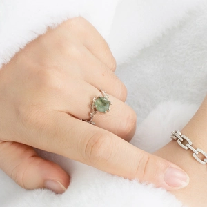 Macro detail of S925 silver vine ring with moss agate stone and paved chain bracelet