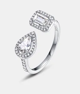 Detailed close-up of S925 silver ring featuring emerald and pear cut halo-set stones