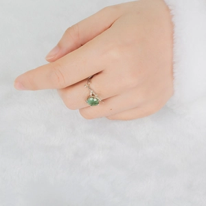 Close-up of S925 silver vine ring featuring a faceted green moss agate gemstone