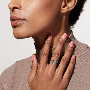 Detail of moss agate ring on hand featuring a unique vintage silver branch textured band