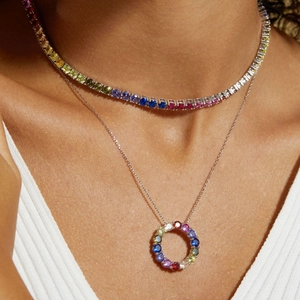 Detail of layered S925 silver tennis chain and rainbow zircon round pendant necklace