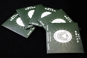 Close-up of anti-tarnish silver polishing cloths in dark green packaging for jewelry care