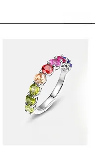 Macro view of a colorful zircon ring featuring rainbow gemstones on a silver band