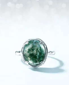 Macro view of S925 sterling silver ring with oval moss agate gemstone in retro setting