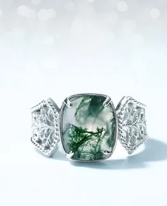 Detailed view of moss agate stone with green inclusions on a vintage S925 silver ring
