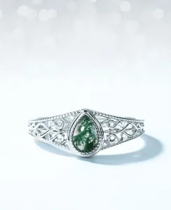 Macro shot of oval moss agate ring with vintage hollow silver craftsmanship
