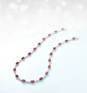 Macro detail of S925 sterling silver necklace with oval red high-carbon diamonds