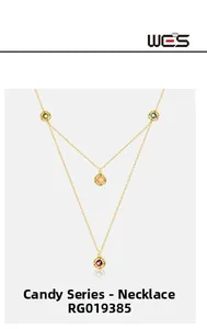 Macro detail of gold-tone double layer necklace featuring colorful bezel-set gemstones