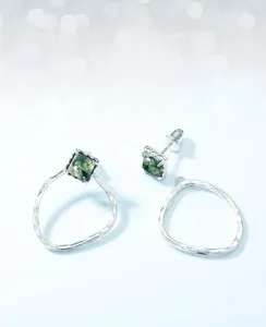 Detail of detachable S925 silver earrings with green moss agate and hammered metal finish