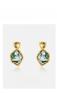 Macro detail of natural green moss agate stud earring with irregular geometric gold setting