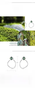 Macro detail of S925 silver earring with square green moss agate stone in natural setting