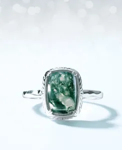Macro shot of rectangular green moss agate set in a minimalist silver open ring band