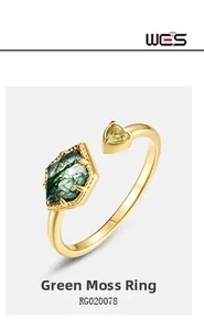Detailed view of moss agate ring with rhombic and triangular green stones in gold finish