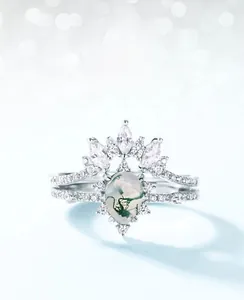 Macro shot of S925 silver pear-shaped moss agate ring with marquise zircon accents