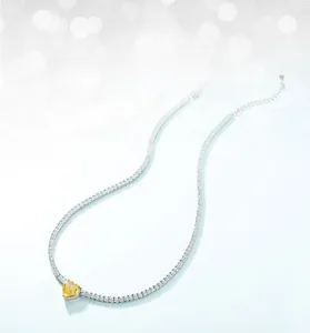 Macro shot of S925 silver tennis chain featuring a heart-shaped yellow carbon diamond