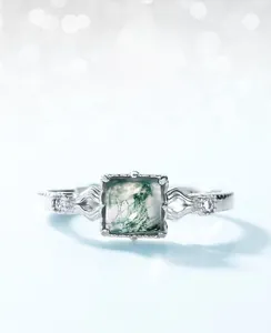 Macro shot of square green moss agate stone with vintage hollow silver ring band details