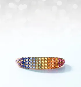 Macro shot of gold-plated rainbow band ring with colorful cubic zirconia stones