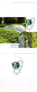 Macro detail of teardrop green moss agate ring in S925 silver with diamond accents